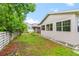 House with backyard, partially fenced, and mature trees at 651 Jungle Queen Way, Longboat Key, FL 34228