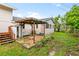 Brick patio, gazebo, and storage shed in a backyard setting at 651 Jungle Queen Way, Longboat Key, FL 34228