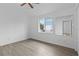 Bright bedroom with wood-look floors and large window at 651 Jungle Queen Way, Longboat Key, FL 34228