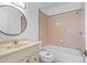 Bathroom with pink tile, vanity, and bathtub at 651 Jungle Queen Way, Longboat Key, FL 34228