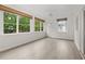Sunroom with multiple windows, light flooring, and white walls at 651 Jungle Queen Way, Longboat Key, FL 34228