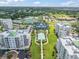 Stunning aerial view of a property featuring well-manicured lawns, a pool, and manicured landscaping at 6 Belleview Blvd # 706, Belleair, FL 33756