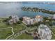 Aerial view of condo buildings near the water and a golf course in a coastal city at 6 Belleview Blvd # 706, Belleair, FL 33756