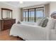 Bright main bedroom featuring a large window overlooking the water and a neutral color palette at 6 Belleview Blvd # 706, Belleair, FL 33756