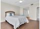 Cozy bedroom featuring wood floors, a ceiling fan, and access to a closet and hallway at 6 Belleview Blvd # 706, Belleair, FL 33756