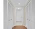 Hallway with closet space and a view to the bathroom featuring neutral paint and tiled flooring at 6 Belleview Blvd # 706, Belleair, FL 33756