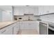 Stylish kitchen with white cabinets, stainless steel appliances, and granite countertops at 6 Belleview Blvd # 706, Belleair, FL 33756