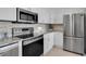 Modern kitchen with stainless steel appliances, white cabinets, and granite countertops at 6 Belleview Blvd # 706, Belleair, FL 33756