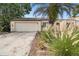 This house has great curb appeal with its beautiful palm tree and attached front garage at 7518 Clanton Trl, Hudson, FL 34667