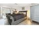Main bedroom with gray upholstered bed and gray dresser at 7518 Clanton Trl, Hudson, FL 34667