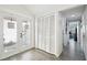 Bright entryway with white louvered doors and grey flooring at 7518 Clanton Trl, Hudson, FL 34667