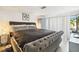 Main bedroom with king-size bed and access to patio at 7518 Clanton Trl, Hudson, FL 34667
