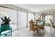 Dining area with glass table and chairs, near sliding glass doors at 7518 Clanton Trl, Hudson, FL 34667