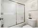 Bathroom with a shower/tub combo and frosted glass door at 7518 Clanton Trl, Hudson, FL 34667