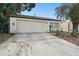 Front of the house showcasing the garage and landscaping at 7518 Clanton Trl, Hudson, FL 34667