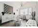 Serene living room with white furniture, a geometric print, and gray floors at 7518 Clanton Trl, Hudson, FL 34667