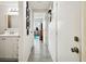 Hallway with light walls, wood-look floors, and access to rooms at 7518 Clanton Trl, Hudson, FL 34667