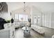 Living room with white furniture, a glass-top coffee table, and a chandelier at 7518 Clanton Trl, Hudson, FL 34667