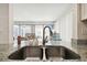 Modern kitchen with granite countertops and stainless steel double sink at 7518 Clanton Trl, Hudson, FL 34667
