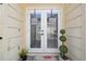 Double glass doors with a welcome mat at the entrance at 7518 Clanton Trl, Hudson, FL 34667