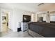 Main bedroom with large TV and gray upholstered bed at 7518 Clanton Trl, Hudson, FL 34667