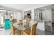 Bright dining area with glass table and wicker chairs, adjacent to kitchen at 7518 Clanton Trl, Hudson, FL 34667