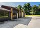 Dark-painted exterior with stone accents and a garage door at 13600 Ponce De Leon Blvd, Brooksville, FL 34601