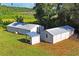 Two long white metal outbuildings in a field at 13600 Ponce De Leon Blvd, Brooksville, FL 34601