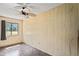 Bedroom with ceiling fan and large window at 13600 Ponce De Leon Blvd, Brooksville, FL 34601