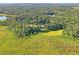 Aerial view showing a house and large property with surrounding forest at 13600 Ponce De Leon Blvd, Brooksville, FL 34601