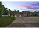 Home with stone accents and large windows at dusk at 13600 Ponce De Leon Blvd, Brooksville, FL 34601