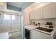 Laundry room with washer, dryer, and cabinets at 13600 Ponce De Leon Blvd, Brooksville, FL 34601