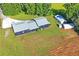 Aerial view showing house, sheds, and surrounding land at 13600 Ponce De Leon Blvd, Brooksville, FL 34601