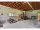 Large garage with high ceilings, tractor, and mower at 13600 Ponce De Leon Blvd, Brooksville, FL 34601