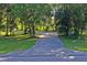 Cracked driveway leading to a property surrounded by trees at 13600 Ponce De Leon Blvd, Brooksville, FL 34601