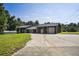 Large building with a garage and ample parking at 13600 Ponce De Leon Blvd, Brooksville, FL 34601