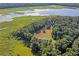 Aerial view showing home near a lake with lush vegetation at 13600 Ponce De Leon Blvd, Brooksville, FL 34601