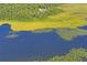 Aerial view of property near lake and lush vegetation at 13600 Ponce De Leon Blvd, Brooksville, FL 34601