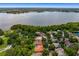 Aerial view of waterfront property with lush landscaping at 4300 Wheatland Way, Palm Harbor, FL 34685