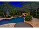 Illuminated pool and spa at night with covered patio at 4300 Wheatland Way, Palm Harbor, FL 34685