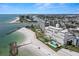 Breathtaking aerial view of a beachfront condominium complex, pool, beach, and surrounding waterways at 7000 Beach Plz # 505, St Pete Beach, FL 33706