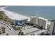 Breathtaking aerial view showcasing the condominium, sandy beach, and picturesque ocean views at 7000 Beach Plz # 505, St Pete Beach, FL 33706