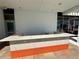 Spacious rooftop bar area with orange and white accent tiles and a stone countertop at 777 3Rd N Ave # 908, St Petersburg, FL 33701