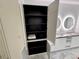Bathroom storage cabinet revealing neatly arranged shelving and towels, complementing the modern double sink vanity at 777 3Rd N Ave # 908, St Petersburg, FL 33701