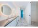 Bright bathroom featuring double sink vanity with sleek countertops, ambient lighting, and ample storage at 777 3Rd N Ave # 908, St Petersburg, FL 33701