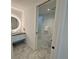 Modern bathroom with a sleek vanity, round LED mirror, and white subway tile at 777 3Rd N Ave # 908, St Petersburg, FL 33701