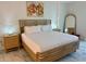 Bright bedroom with a wood-framed bed, modern nightstands, and stylish decor at 777 3Rd N Ave # 908, St Petersburg, FL 33701