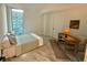 Bedroom featuring a work desk by the window and modern furnishings, with bright light at 777 3Rd N Ave # 908, St Petersburg, FL 33701