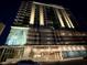 Night view of a modern condominium building showing lighting, balconies, mural and parking garage at 777 3Rd N Ave # 908, St Petersburg, FL 33701