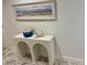 Hallway table with blue ceramic vase and artwork above, complementing the marble floors at 777 3Rd N Ave # 908, St Petersburg, FL 33701